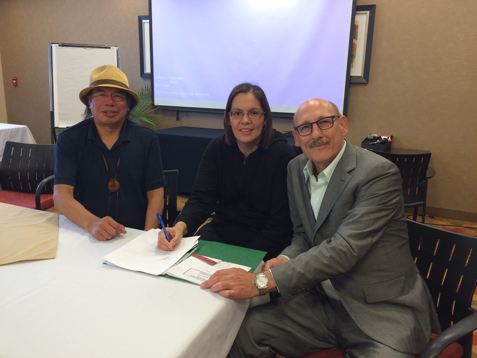 Geordi Kakepetum, CEO, NCC Development LP, Chief Vontaine Keno of McDowell Lake  and David Arenberg, VP, Canadian Solar sign an agreement to install a 10 kW solar system in the small remote First Nation north of Red Lake, Ontario
