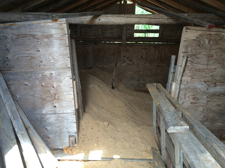 Before this new system was installed to power a community freezer and fridge, the ice house and sawdust were used to store ice over the summer.